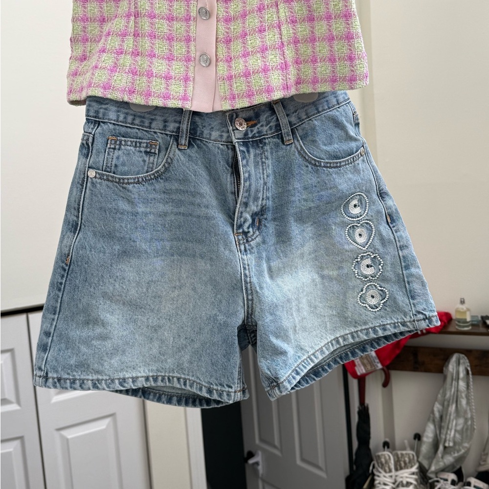 CHANEL Light Blue Denim Shorts with Decorative Side Motifs